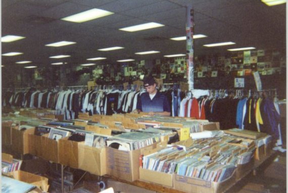 Picture of some of their LPs. Young man is a store employee.